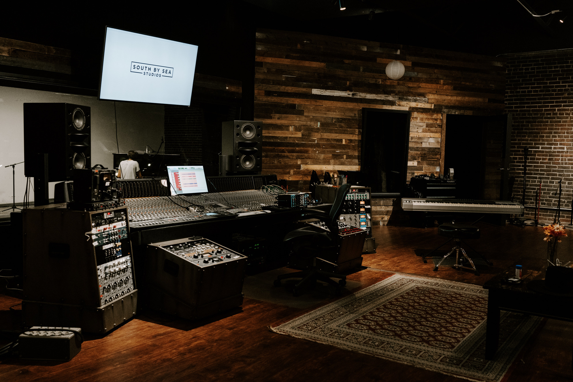 Studio A — flagship control room with reclaimed wood and vintage console